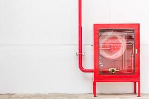 Red fire hose cabinet and extinguisher