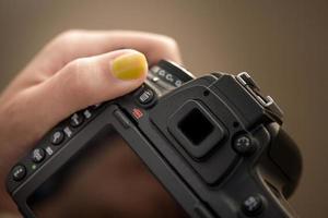 DSLR camera in womans hands