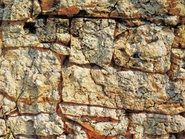 Detalle de la pared de piedra al aire libre para el fondo o la textura foto