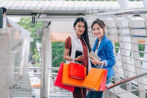 Two women holding shopping bags photo
