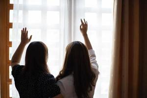 Two women in prayer in a window