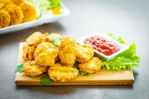 Deep fried chicken nuggets with ketchup photo