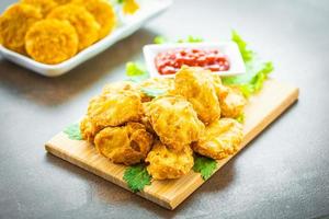 Deep fried chicken nuggets with ketchup photo