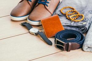 Clothes and fashion accessories on wooden floor photo