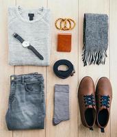 Clothes and fashion accessories on wooden floor photo