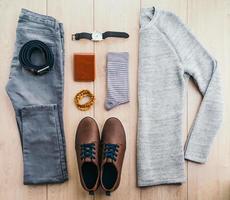 Clothes and fashion accessories on wooden floor photo