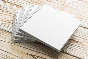 Blank notebook mock up on wooden background photo