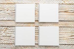 Blank notebook mock up on wooden background photo