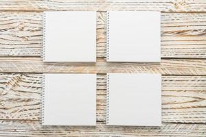 Blank notebooks on wooden background photo