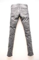 Gray jeans on white background photo