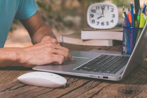 A person typing on a laptop computer photo