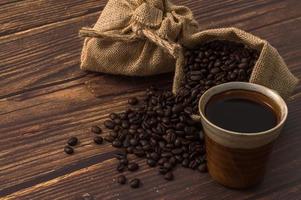 Coffee mug and coffee beans on the table photo