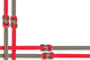 Different ropes tied together isolated on a white background photo