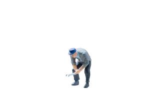 Miniature construction worker concept isolated on a white background photo