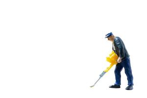 Miniature construction worker concept isolated on a white background photo