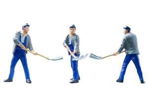 Miniature construction workers concept isolated on a white background photo