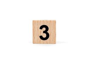 Wooden block number three on a white background