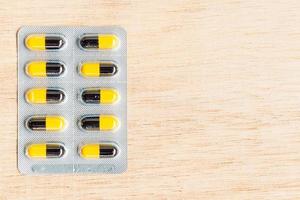 Pills in a blister pack on a wooden background
