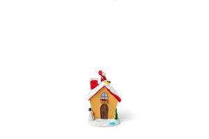 Christmas scene of Santa Claus figurine sitting on a roof on a white background photo