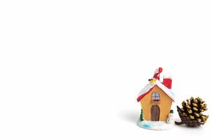 Christmas scene of Santa Claus figurine sitting on a roof on a white background photo
