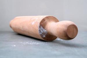 Close-up of a rolling pin on a gray surface photo