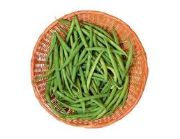 Green beans in a wicker basket isolated on a white background