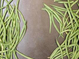 Green beans on a dark table background