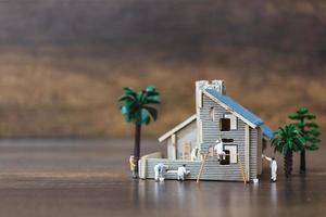 Miniature workers painting a new home, renovation concept photo