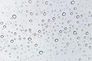 Raindrops on a window glass surface photo