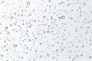 Raindrops on a window glass surface photo