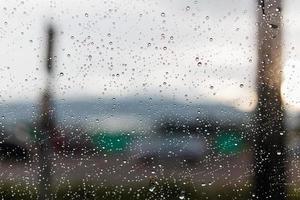 Raindrops on a window glass surface photo