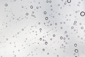 Raindrops on a window glass surface photo