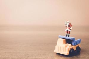 Miniature Santa Claus carrying a bag, Christmas celebration concept photo