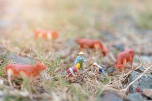 Miniature gardeners working on the field, farmer and gardening concept photo