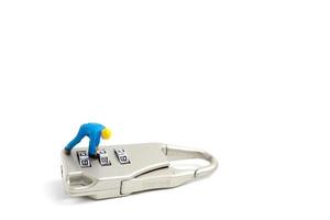 Miniature worker unlocking the password on a lock, teamwork concept photo