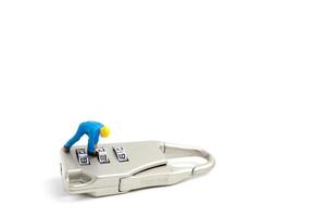 Miniature worker unlocking the password on a lock, teamwork concept photo