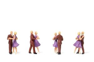 Miniature couple dancing romantically on a white background, Valentine's Day concept photo