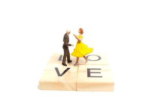 Miniature couple dancing romantically on a white background, Valentine's Day concept photo