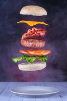 Floating hamburger with bacon and cheese photo