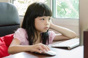 Bored girl at computer photo