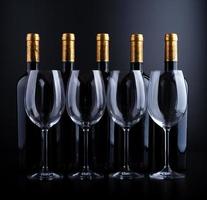 Wine bottles and glass with black background