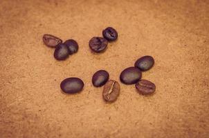 Coffee beans on a brown surface photo