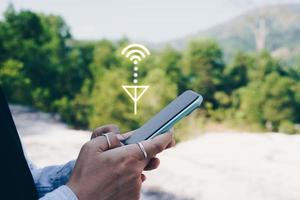 Person using smartphone looking for wifi signal photo