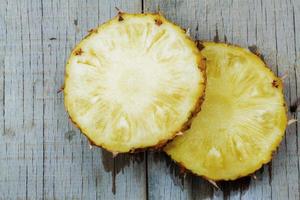 Pineapple cut on a wooden table photo