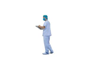 Miniature doctors with protective suits and masks on a white background photo