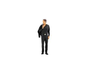 Miniature businessman standing isolated on a white background photo