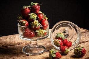 Strawberries in a glass on a table photo