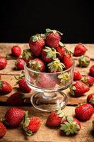 Strawberries in a glass and on a table photo