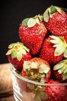 Macro close up of strawberries on a wooden table photo