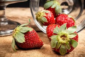 Strawberries in a glass on a wooden table photo